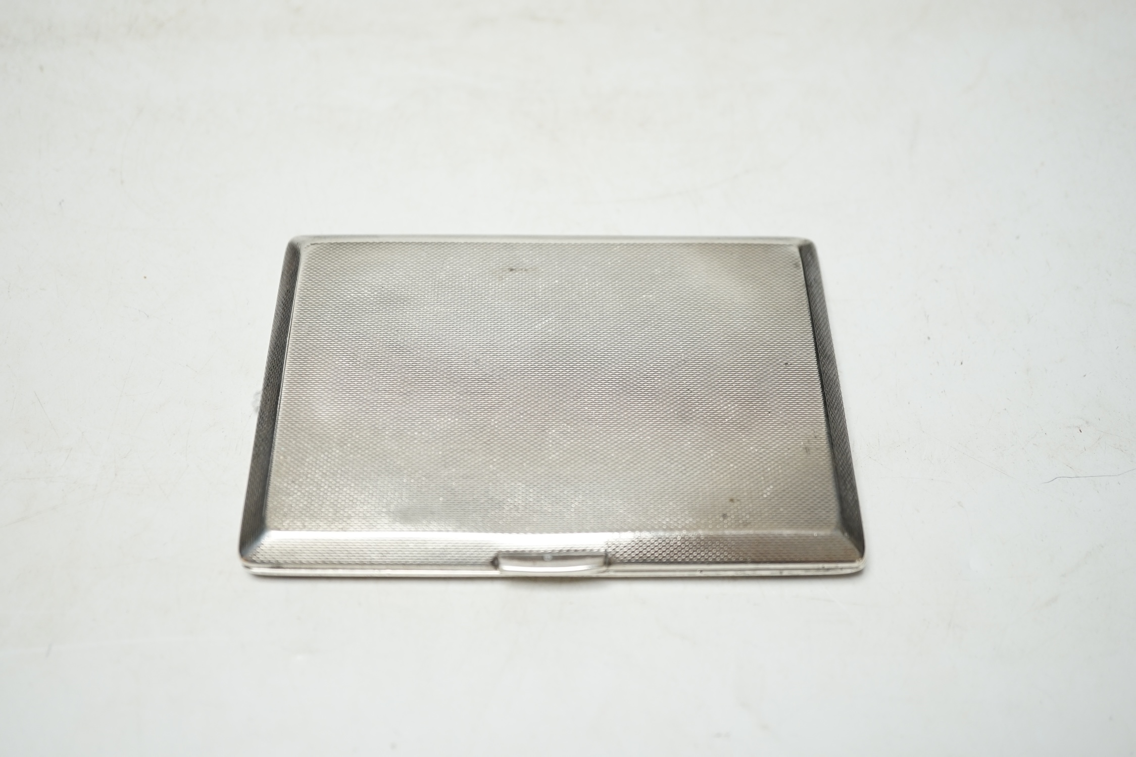 A George VI engine turned silver cigarette case, Birmingham, 1948, 11.6cm. Condition - fair